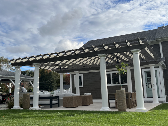 A simple fiberglass pergola beside a pool