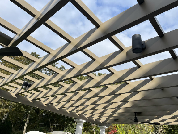 A simple fiberglass pergola beside a pool