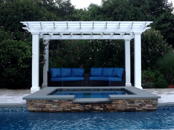 A simple fiberglass pergola beside a pool