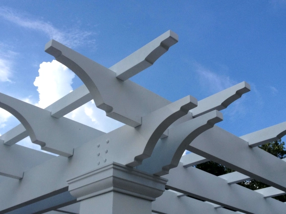 A simple fiberglass pergola beside a pool