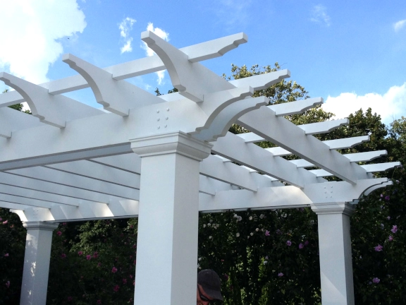 A simple fiberglass pergola beside a pool