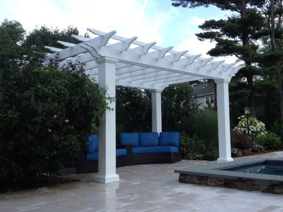 A simple fiberglass pergola beside a pool