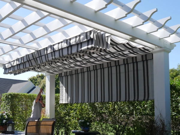 A simple fiberglass pergola beside a pool